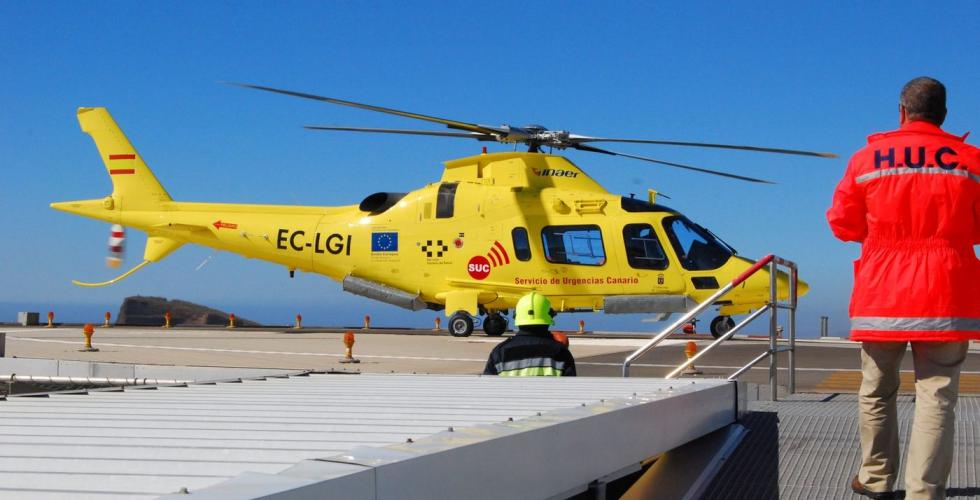 Helsearbeider på vei mot et ambulansehelikopter på heliplattform.